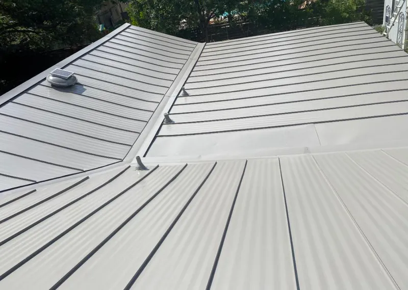 Solar attic fan installed on a metal roof for Roof Ventilation in Timberlake